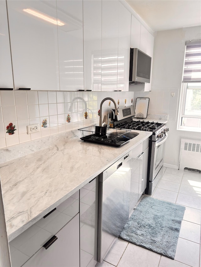 30-11 Parsons Blvd Unit 3P, Flushing, NY 11354 - kitchen featuring radiator heating unit, appliances with stainless steel finishes, modern cabinets, and white cabinets