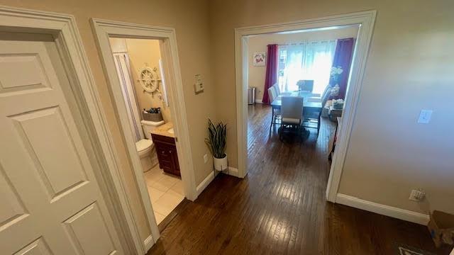 2568 Seminole Ave, Seaford, NY 11783 - hallway featuring dark wood-style floors