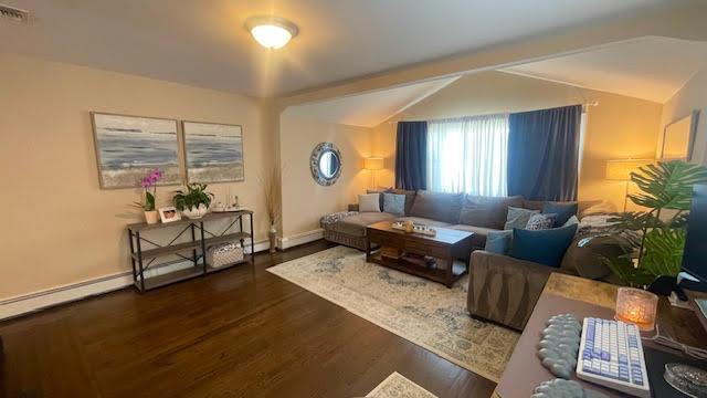 2568 Seminole Ave, Seaford, NY 11783 - living room featuring vaulted ceiling and wood finished floors