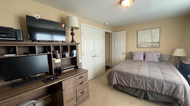 2568 Seminole Ave, Seaford, NY 11783 - bedroom with light carpet, an office area, and a closet