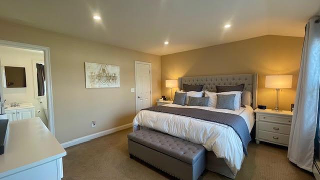 2568 Seminole Ave, Seaford, NY 11783 - carpeted bedroom with ensuite bath and recessed lighting