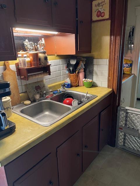 39 Harrison St, Middletown, NY 10940 - kitchen with light countertops, a sink, and backsplash