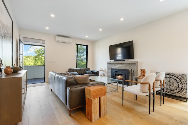 290 Mountain Rd, Pleasantville, NY 10570 - living room featuring a wall mounted AC, a glass covered fireplace, light wood-type flooring, and recessed lighting