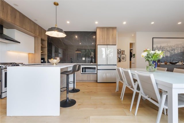 290 Mountain Rd, Pleasantville, NY 10570 - kitchen with white appliances, modern cabinets, a kitchen breakfast bar, a kitchen island, and light countertops