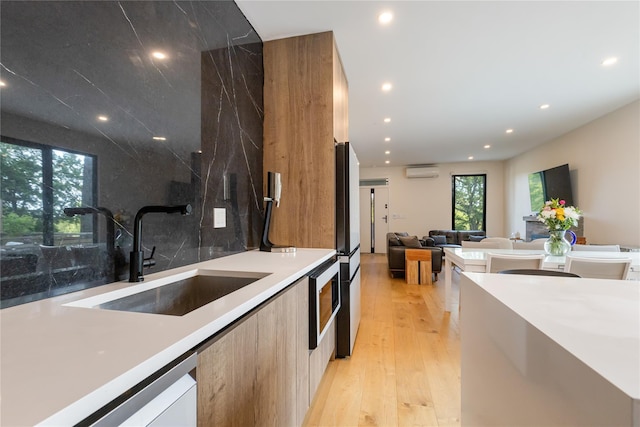 290 Mountain Rd, Pleasantville, NY 10570 - kitchen featuring modern cabinets, a wall mounted AC, recessed lighting, light wood finished floors, and light countertops