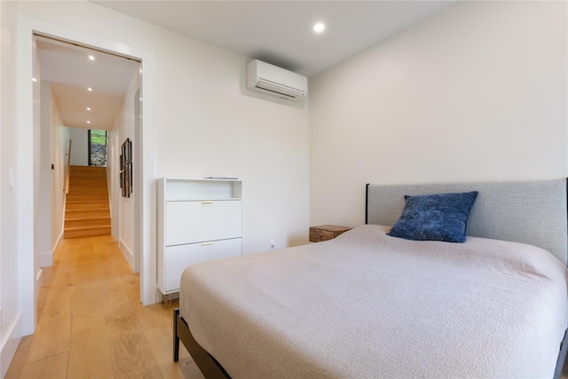 290 Mountain Rd, Pleasantville, NY 10570 - bedroom featuring a wall mounted air conditioner, light wood-style flooring, and recessed lighting