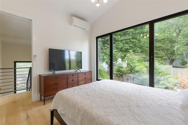 290 Mountain Rd, Pleasantville, NY 10570 - bedroom featuring a wall unit AC, light wood-type flooring, and vaulted ceiling