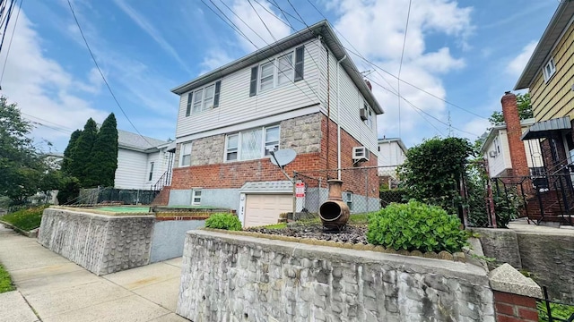 136-23 61st Rd, Flushing, NY 11367 - view of front of house featuring a garage and brick siding
