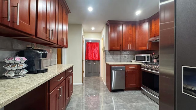 136-23 61st Rd, Flushing, NY 11367 - kitchen with appliances with stainless steel finishes, under cabinet range hood, tasteful backsplash, baseboards, and light stone countertops