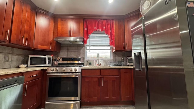 136-23 61st Rd, Flushing, NY 11367 - kitchen with appliances with stainless steel finishes, a sink, under cabinet range hood, decorative backsplash, and dark brown cabinets