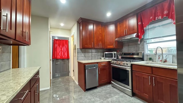 136-23 61st Rd, Flushing, NY 11367 - kitchen with appliances with stainless steel finishes, a sink, under cabinet range hood, tasteful backsplash, and baseboards