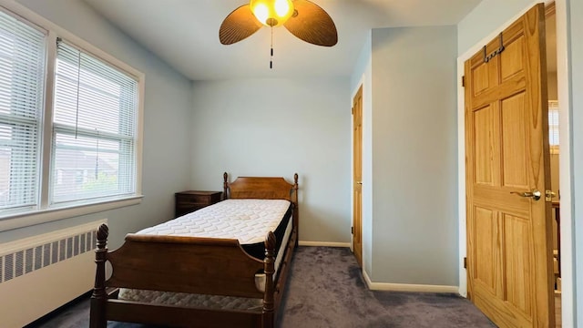 136-23 61st Rd, Flushing, NY 11367 - bedroom with radiator, dark carpet, baseboards, and a ceiling fan