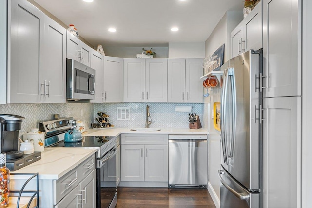 9-05 166th St Unit 4A, Beechhurst, NY 11357 - kitchen featuring appliances with stainless steel finishes, a sink, dark wood-style floors, decorative backsplash, and recessed lighting