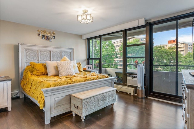 9-05 166th St Unit 4A, Beechhurst, NY 11357 - bedroom with a baseboard heating unit, dark wood-style flooring, multiple windows, and a chandelier