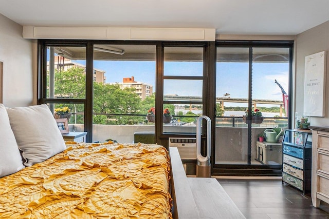 9-05 166th St Unit 4A, Beechhurst, NY 11357 - bedroom with dark wood-style floors and a wall unit AC