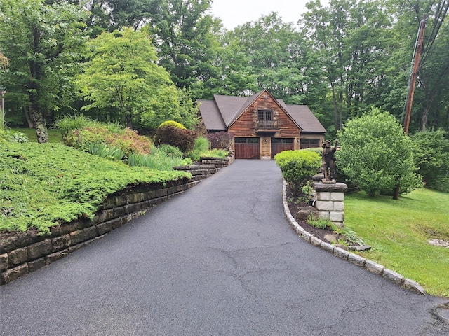 1002 Kitchawan Rd, Ossining, NY 10562 - view of front of house featuring a wooded view, driveway, and a front yard