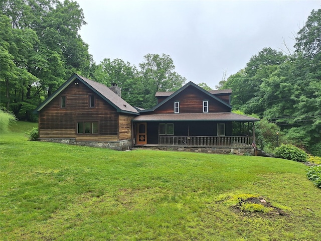 1002 Kitchawan Rd, Ossining, NY 10562 - view of front of home with a front lawn, a porch, and a chimney