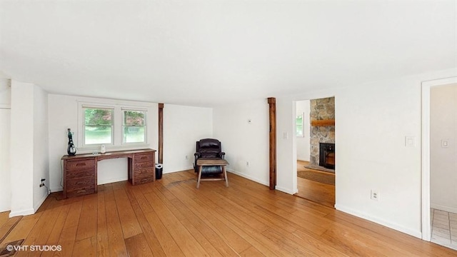 1002 Kitchawan Rd, Ossining, NY 10562 - unfurnished room with light wood-type flooring and a fireplace