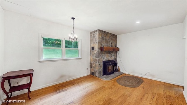 1002 Kitchawan Rd, Ossining, NY 10562 - unfurnished living room featuring wood finished floors, a fireplace, and a chandelier