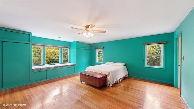 1002 Kitchawan Rd, Ossining, NY 10562 - bedroom with multiple windows, light wood-style flooring, and a ceiling fan