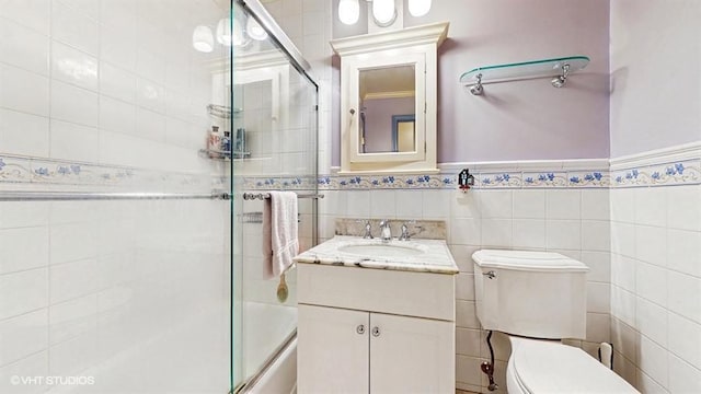 1002 Kitchawan Rd, Ossining, NY 10562 - bathroom featuring enclosed tub / shower combo, vanity, wainscoting, and tile walls