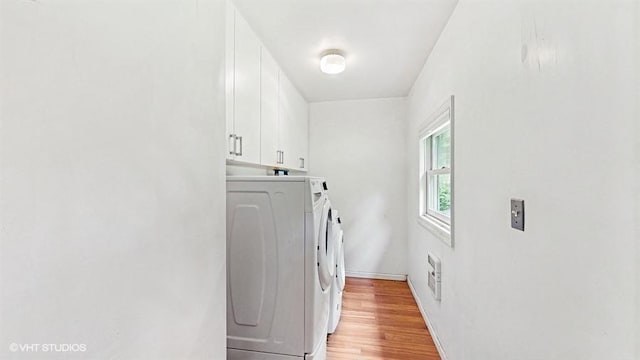 1002 Kitchawan Rd, Ossining, NY 10562 - laundry room featuring independent washer and dryer, cabinet space, and light wood finished floors