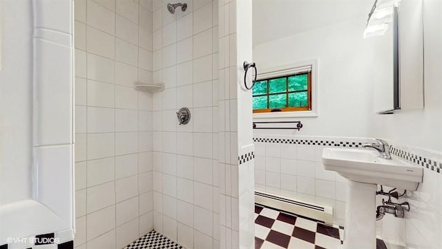 1002 Kitchawan Rd, Ossining, NY 10562 - bathroom featuring a baseboard radiator, tiled shower, tile walls, tile patterned floors, and wainscoting