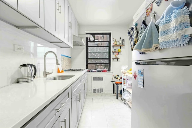 26-20 141st St Unit 4A, Flushing, NY 11354 - kitchen featuring freestanding refrigerator, a sink, radiator heating unit, light countertops, and light tile patterned flooring
