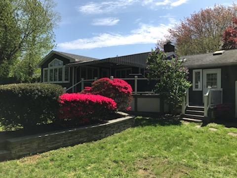 109 Dogwood Ln, Port Jefferson, NY 11777 - rear view of house with a yard