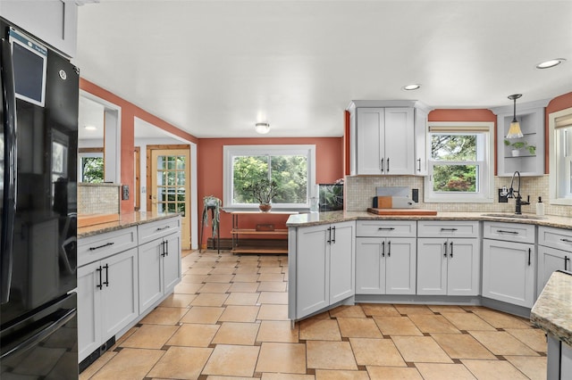 3841 Indian Hill Rd, Shrub Oak, NY 10588 - kitchen with freestanding refrigerator, decorative backsplash, recessed lighting, healthy amount of natural light, and light stone counters