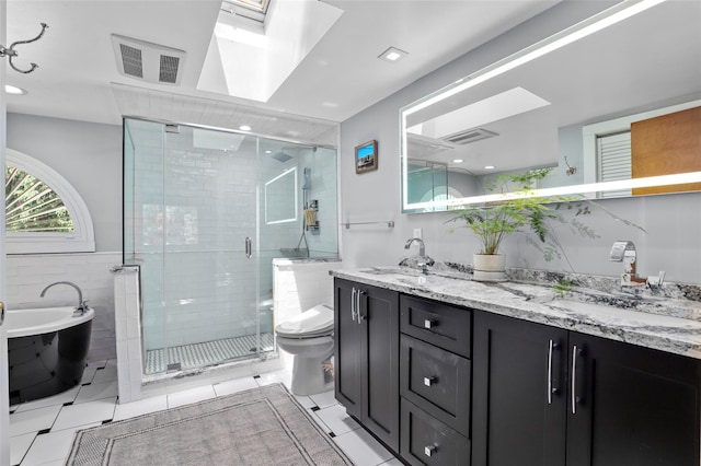3841 Indian Hill Rd, Shrub Oak, NY 10588 - bathroom featuring double vanity, a skylight, a freestanding tub, a stall shower, and tile patterned floors