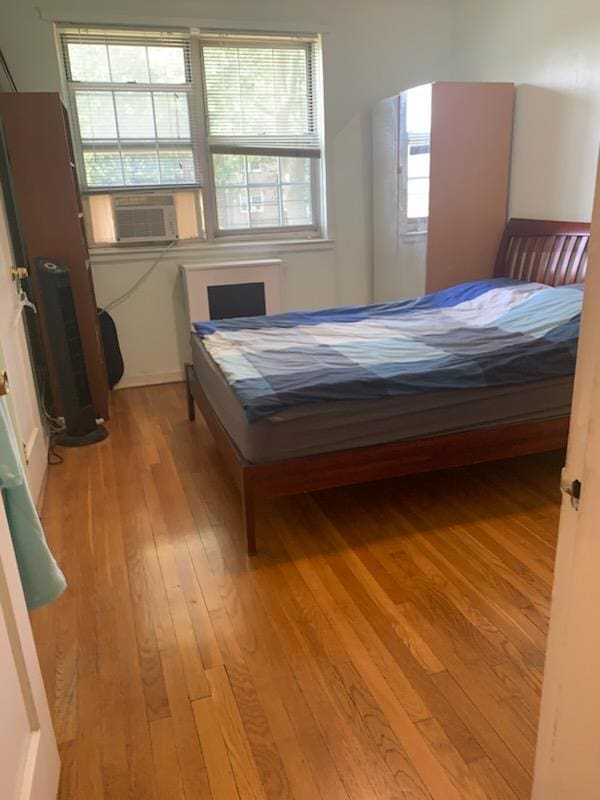 13539 78th Ave Unit 23B, Flushing, NY 11367 - bedroom with light wood finished floors and cooling unit
