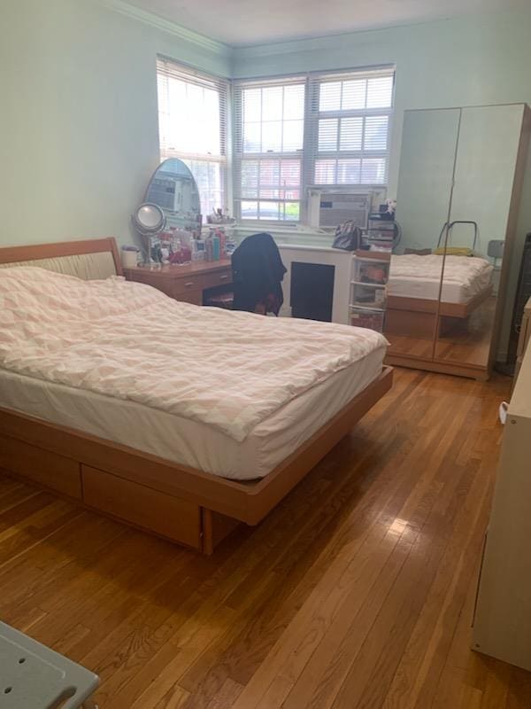 13539 78th Ave Unit 23B, Flushing, NY 11367 - bedroom with wood finished floors, crown molding, cooling unit, and multiple windows