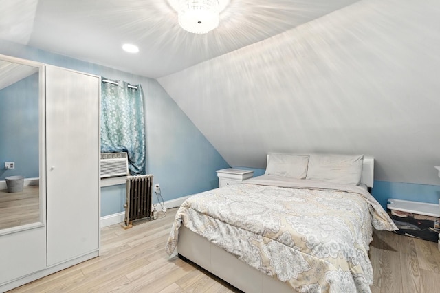 26 Fieldmere St, Elmont, NY 11003 - bedroom featuring radiator heating unit, wood finished floors, and lofted ceiling