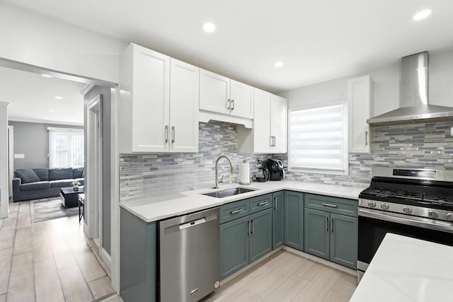 26 Fieldmere St, Elmont, NY 11003 - kitchen with appliances with stainless steel finishes, wall chimney range hood, white cabinets, backsplash, and recessed lighting