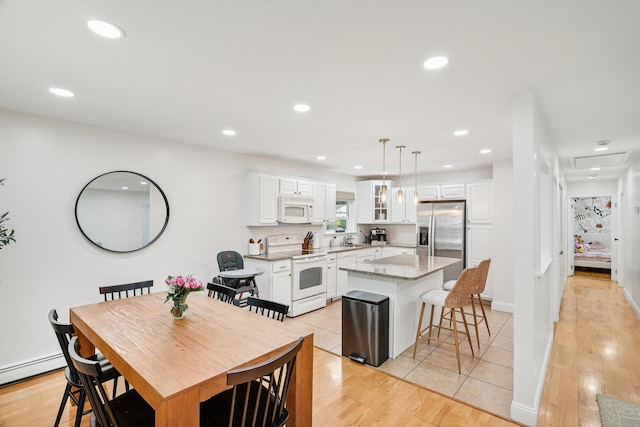 52 Iroquois Trl, Ridge, NY 11961 - dining room featuring recessed lighting, light wood-style floors, and a baseboard radiator