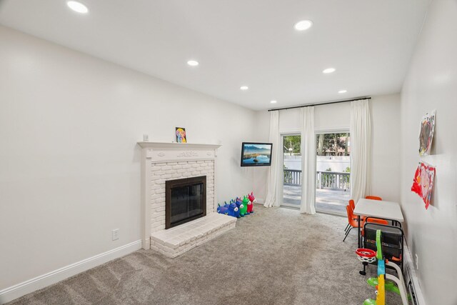 52 Iroquois Trl, Ridge, NY 11961 - playroom with carpet flooring, recessed lighting, baseboards, and a brick fireplace