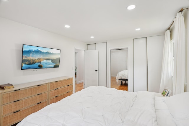 52 Iroquois Trl, Ridge, NY 11961 - bedroom with two closets, recessed lighting, and light wood-type flooring