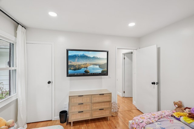 52 Iroquois Trl, Ridge, NY 11961 - bedroom with light wood finished floors, multiple windows, and recessed lighting