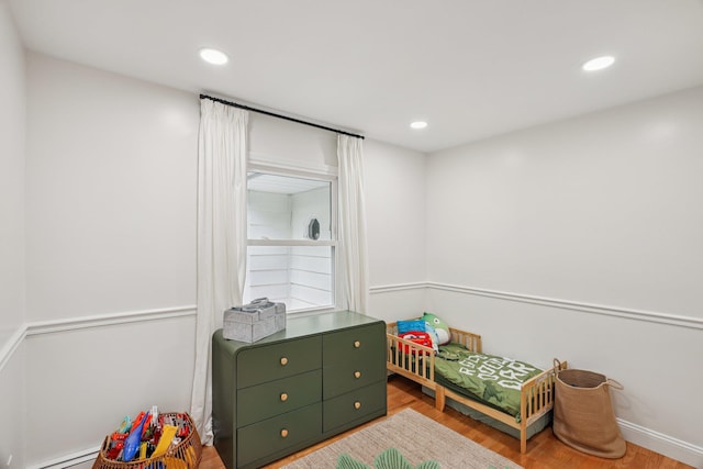 52 Iroquois Trl, Ridge, NY 11961 - bedroom featuring wood finished floors, recessed lighting, and a baseboard radiator