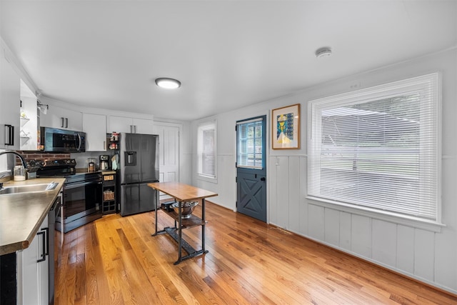 1302 Rte 22 Unit 1300, Brewster, NY 10509 - kitchen with refrigerator with ice dispenser, stainless steel range with electric stovetop, a sink, light wood-type flooring, and dark countertops