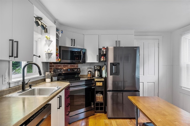 1302 Rte 22 Unit 1300, Brewster, NY 10509 - kitchen featuring appliances with stainless steel finishes, a sink, light wood finished floors, white cabinets, and light countertops