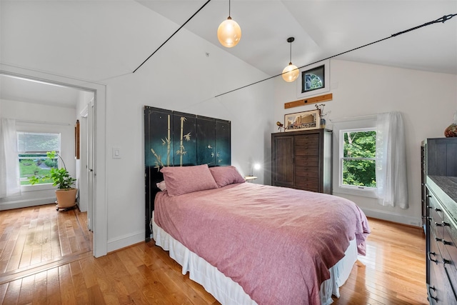 1302 Rte 22 Unit 1300, Brewster, NY 10509 - bedroom with multiple windows, light wood-type flooring, baseboards, and vaulted ceiling
