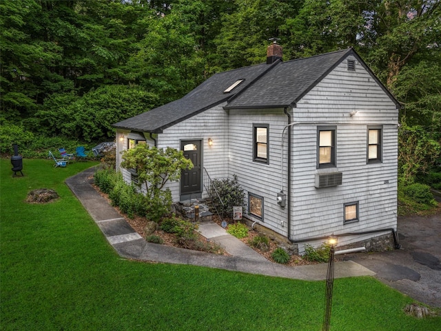 1302 Rte 22 Unit 1300, Brewster, NY 10509 - view of front of house with roof with shingles, a front yard, a chimney, and cooling unit