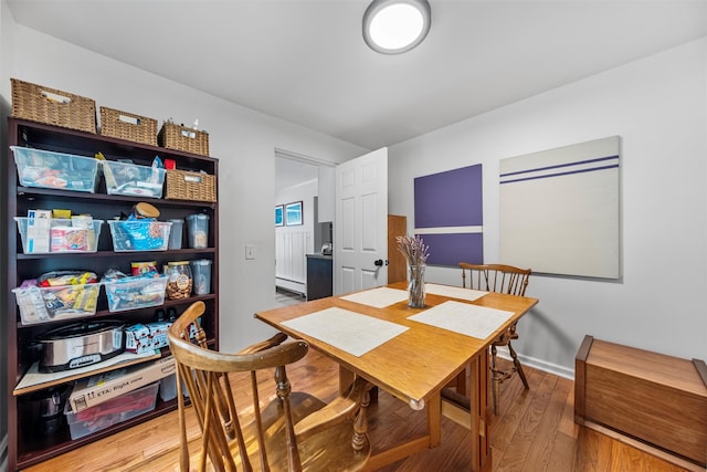 1302 Rte 22 Unit 1300, Brewster, NY 10509 - dining area with wood finished floors, a baseboard radiator, and baseboards
