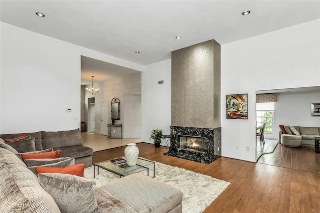 165 Country Club Dr, Commack, NY 11725 - living area featuring a fireplace, a chandelier, wood-type flooring, and recessed lighting