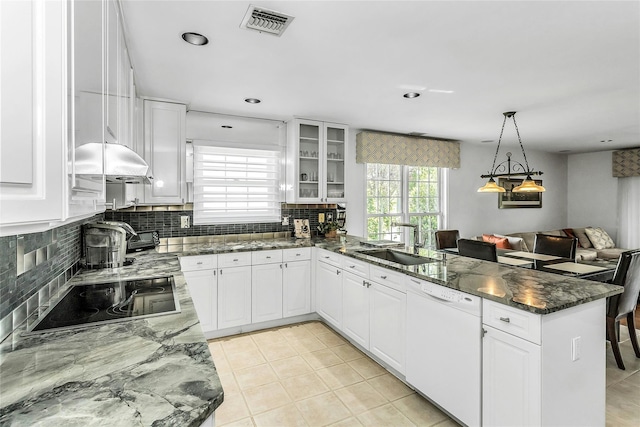 165 Country Club Dr, Commack, NY 11725 - kitchen with white dishwasher, a peninsula, a sink, black electric stovetop, and tasteful backsplash