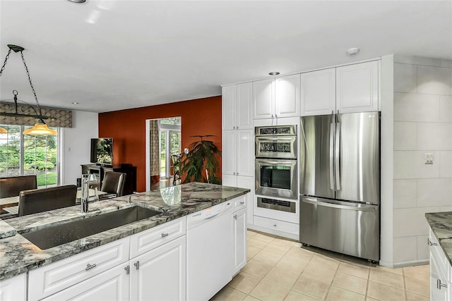 165 Country Club Dr, Commack, NY 11725 - kitchen featuring appliances with stainless steel finishes, a sink, dark stone countertops, and plenty of natural light