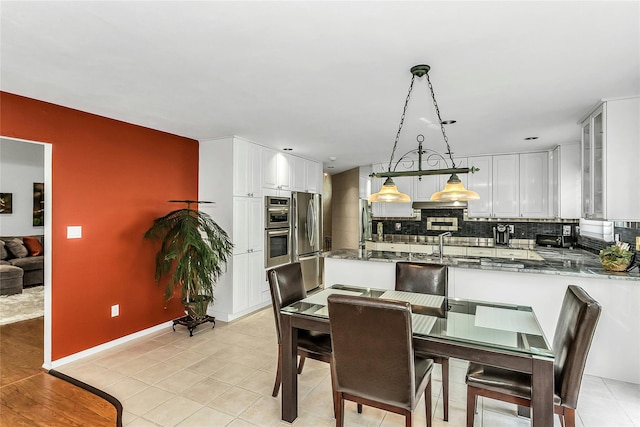 165 Country Club Dr, Commack, NY 11725 - dining area with baseboards and light tile patterned floors