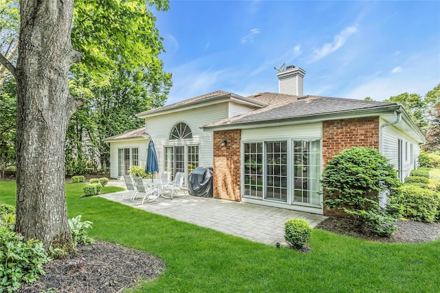 165 Country Club Dr, Commack, NY 11725 - back of property featuring a chimney, brick siding, a yard, and a patio area